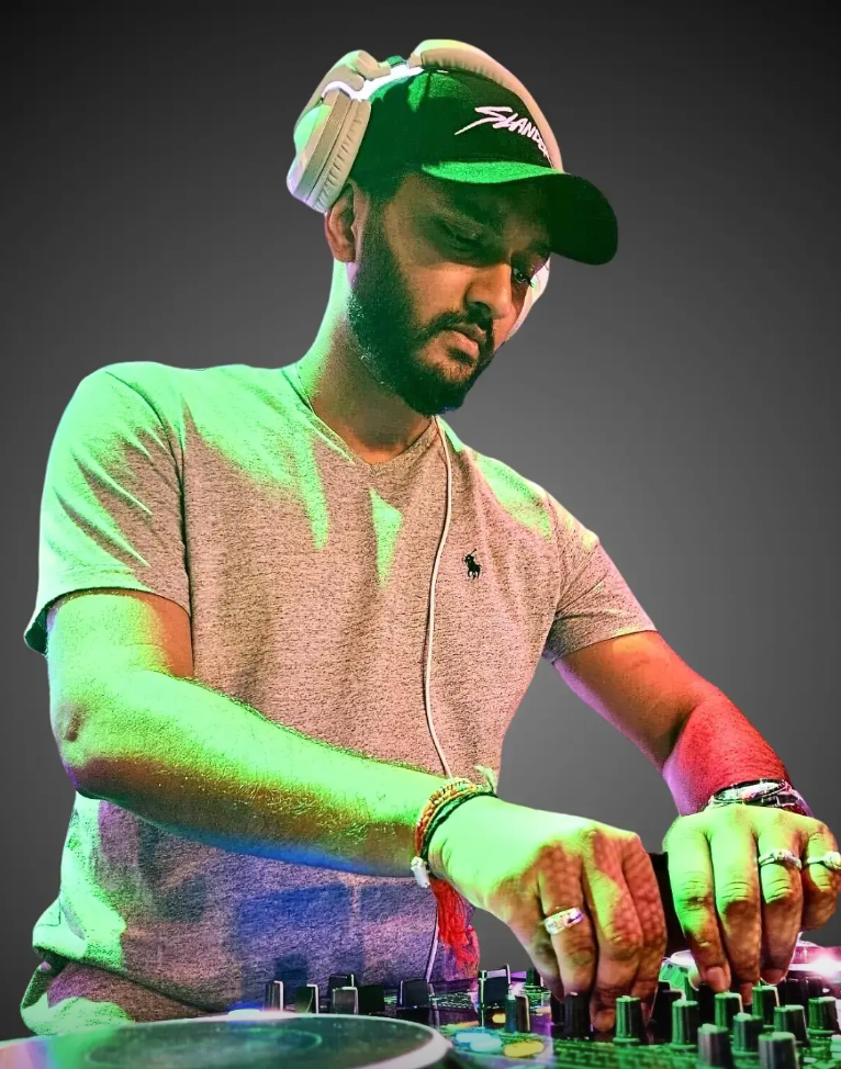 DJ Mit wearing headphones and performing on the decks