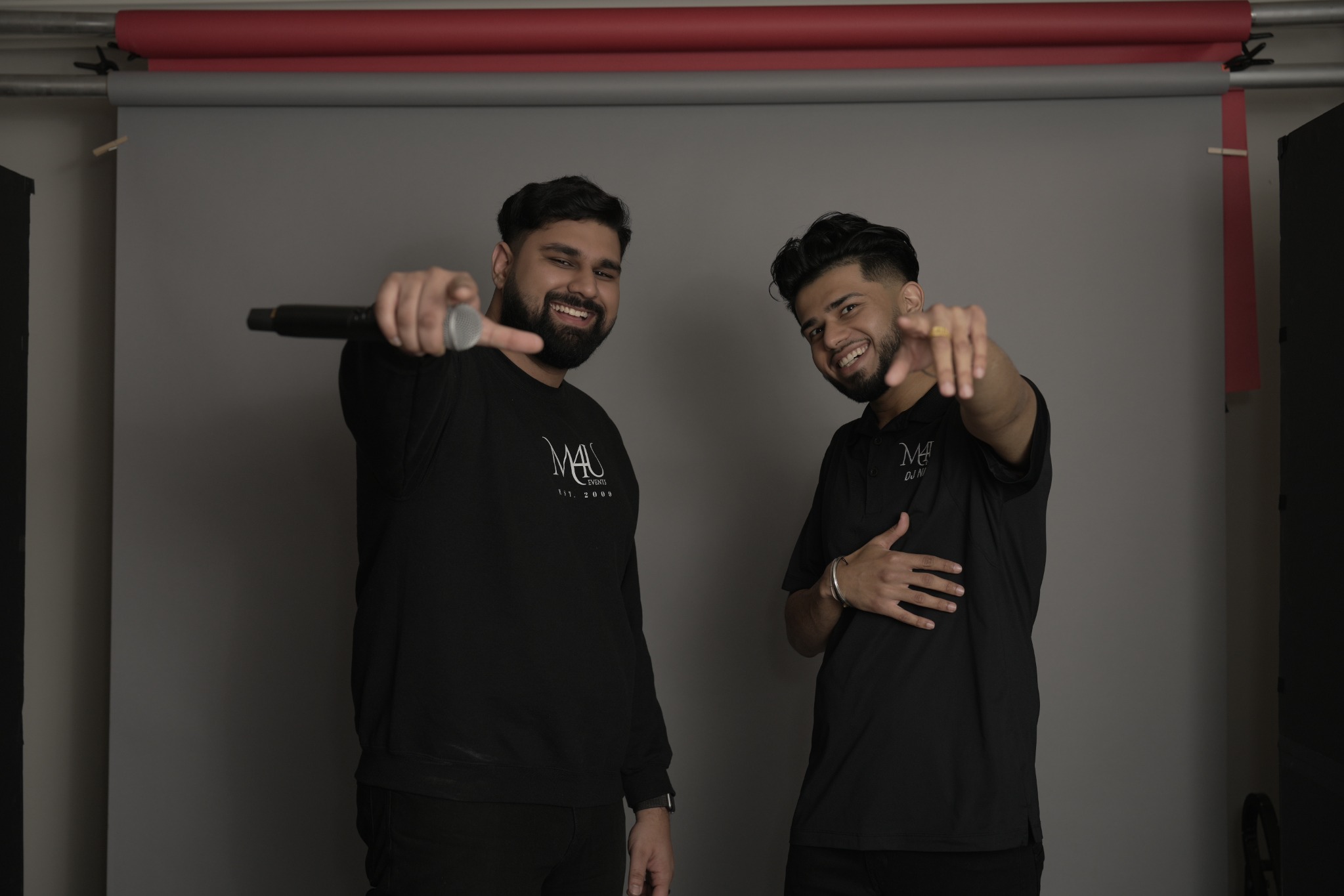 SharmaSync pointing toward the camera during a studio session