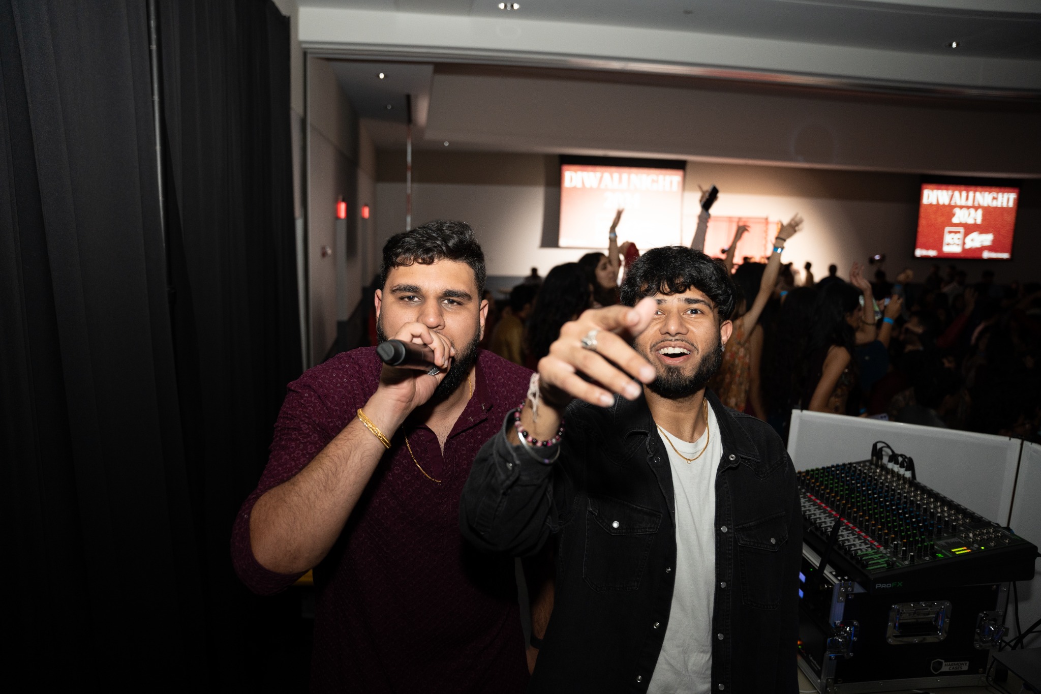 SharmaSync performing together in front of a dance floor