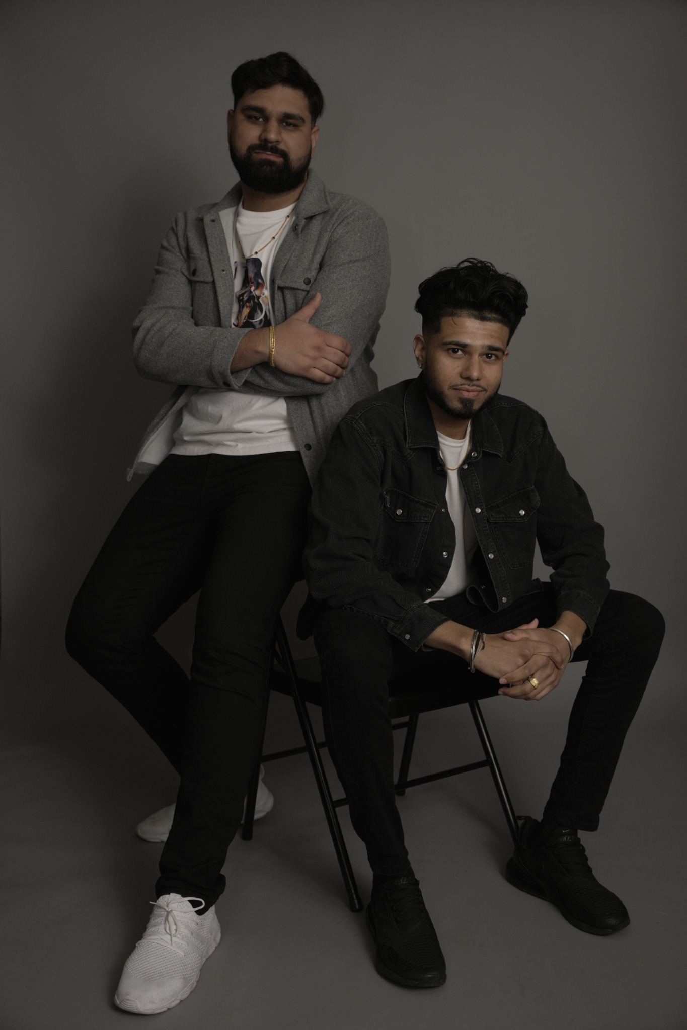SharmaSync seated together for a studio portrait